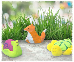 Completed Model Magic rock art crafts with a snail, fox, and turtle