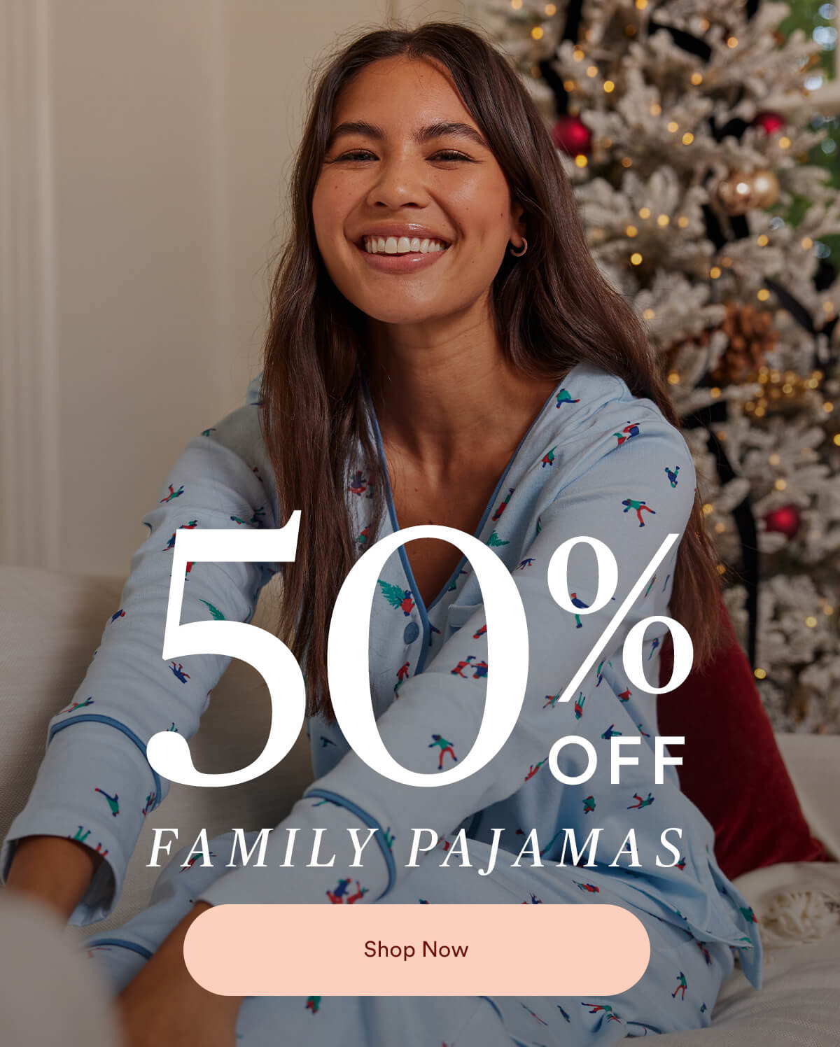 50% off Family Pajamas. Women smiling in front of Christmas tree wearing Summersalt Cotton Family Pajamas