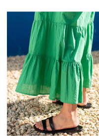 Woman wearing green tiered maxi dress