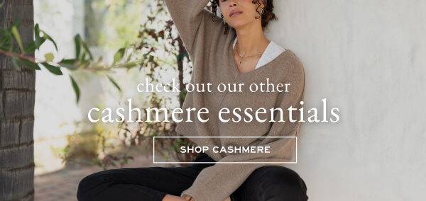 Check out our other cashmere essentials - Shop cashmere - Image of a woman wearing a brown cashmere v-neck sweater