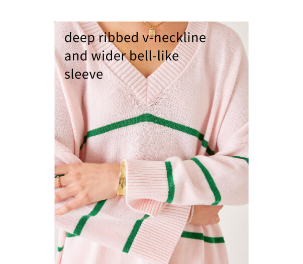 Deep ribbed v-neckline and wider bell-like sleeve - close up of sleeve and neckline of a pink sweater with green stripes