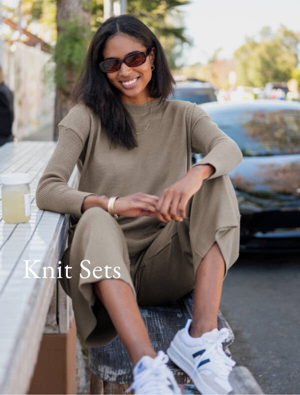 Knit Sets - Image of a woman sitting wearing a brown sweater with matching pants