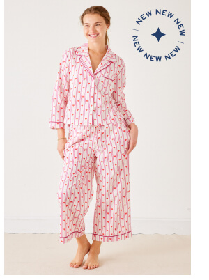 Image of a woman wearing a pajama set with pink stripes and hearts