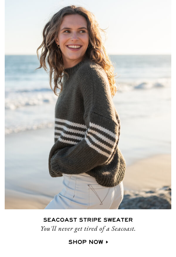 Seacoast Stripe Sweater - You'll never get tired of a Seacoast. Shop Now - woman on beach wearing green sweater with stripes