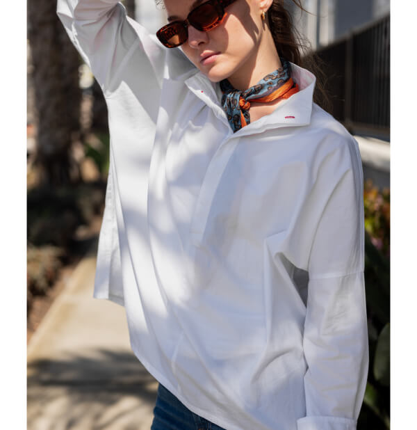 image of woman on sidewalk wearing white top