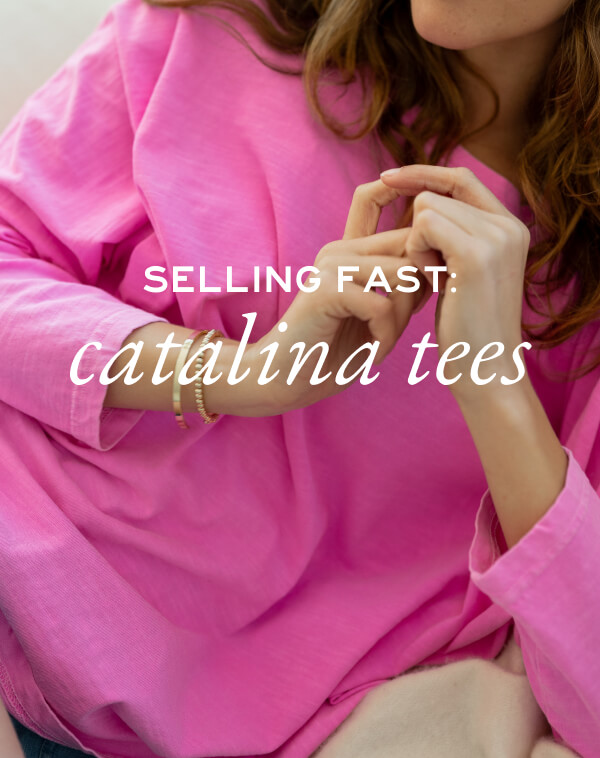 Selling Fast - Catalina Tees - woman on couch wearing hot pink tee