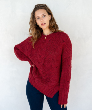 Image of a woman in a red cable knit sweater