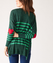 Image of a woman in a green striped sweater with red heart patches on the elbow