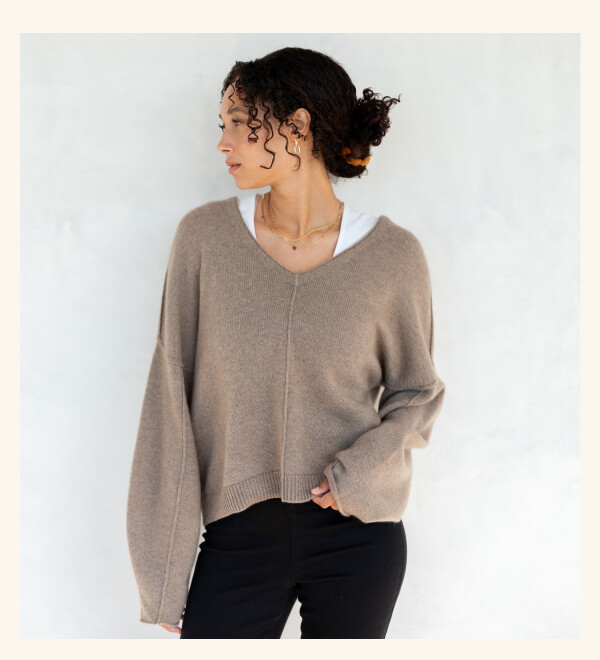 Image of a woman in a tan cashmere sweater