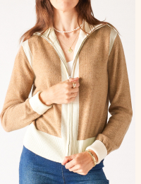 Image of a woman in a white and tan cashmere zip up sweater