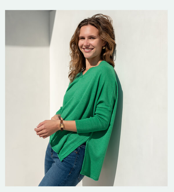 Image of a woman wearing a green v-neck sweater