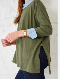 Image of a woman wearing a green long sleeve tee