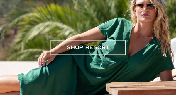 Shop resort - Image of a woman wearing a green coverup laying by the pool