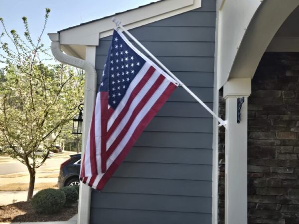 American flag hanging in front of a home - CADRE Dispatch Blog