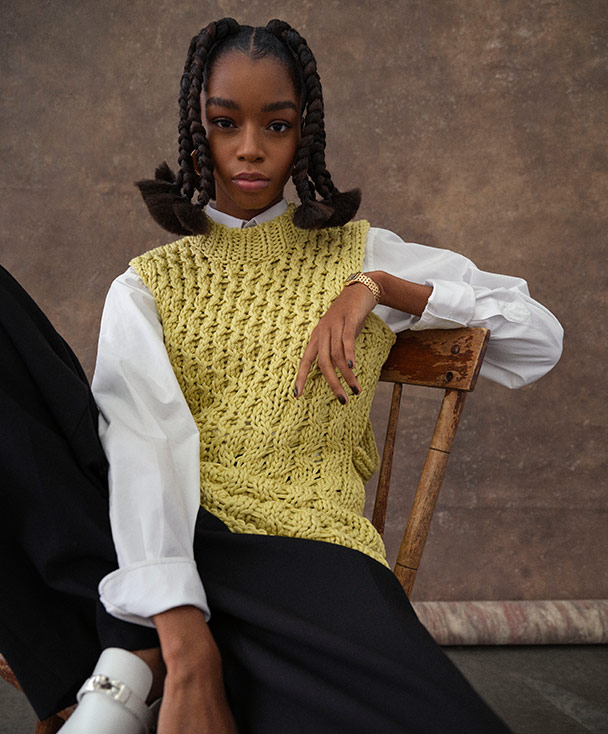 Woman wearing knit vest looking at camera