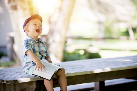 Boy reading and laughing