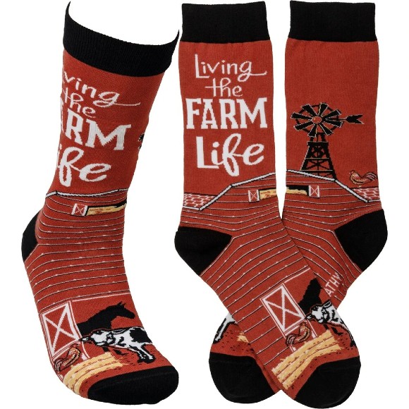 Red socks with "Living the Farm Life" slogan and illustrations of cows and horses on a farm