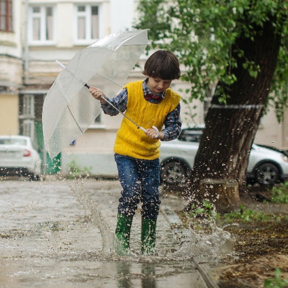 Boy with umbrella in the rain