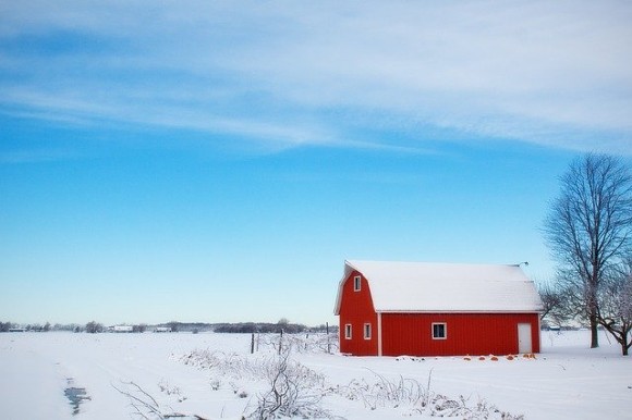 A red barn in a snowy field