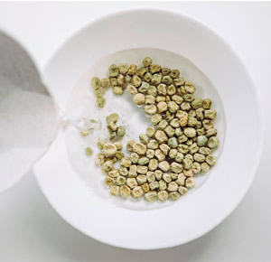 Pictured: Seeds in a white bowl with water being poured over them
