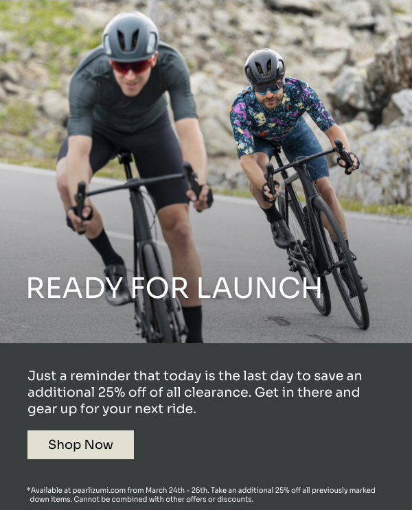 Two road cyclists lean into a turn