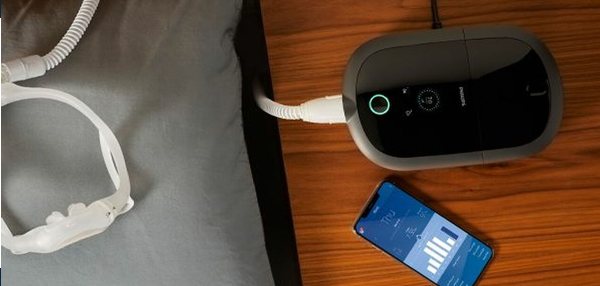 Man lying comfortably in bed using a CPAP machine